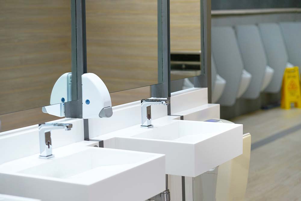 Sink in toilet with blur urinal and awareness board for cleaning area ,no entry